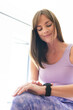© Wavebreak Media - Caucasian woman checks her fitness tracker after a workout, with copy space