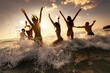 © cppzone - Large group of happy young friends of tourists are having fun, runs and jumps at sunset sea beach. Tropical weekend concept