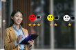 © NINENII - Woman holding a digital tablet with checkboxes rating smiley faces excellent for Satisfaction Survey, Happy Client Customer Experience concept.