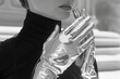 Futuristic metallic gloves in silver, paired with a high-concept, space-age fashion ensemble,