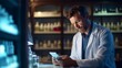 © liliyabatyrova - A tired Male pharmacist is sitting at a table with a tablet computer in a modern light pharmacy. Medical worker, pharmaceutical business, Healthcare concepts.