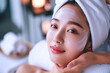 Beautician doing facial skin care for Korean girl in beauty salon