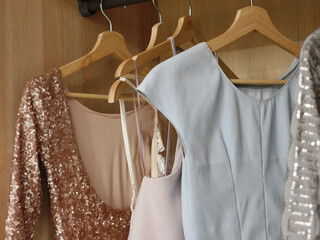 Women's clothing on hangers in wardrobe