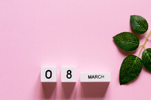 Women's Day Composition. 8 March Wooden Calendar With A Branch Of Green Leaves On The Pink Background. Copy Space, Top View