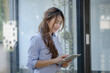 © SOMKID - Happy asian young businesswoman using digital tablet standing in office  working space.