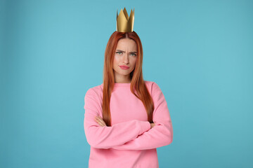 Poster - Emotional young woman with princess crown on light blue background