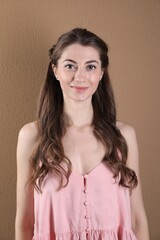 Poster - Woman with wavy hair on light brown background