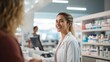 © liliyabatyrova - A young smiling female pharmacist behind the counter sells medicines to pharmacy customers. Medical care, Healthcare concepts.
