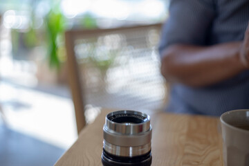 Wall Mural - ,Close-up of hand holding camera,Close-up of camera,Close-up of hand holding camera lens,Old vintage camera placed on a blurred background