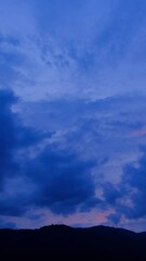 Wall Mural - breathtaking scene of the sun setting over the majestic mountains time lapse video, painting the sky