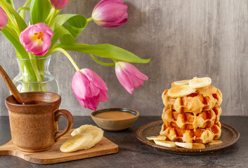 Wall Mural - Homemade breakfast with Belgian waffles, peanut butter and bananas. Grey background.