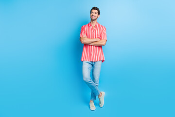 Poster - Full body photo of nice guy wear stylish shirt jeans trousers palms folded look at discount empty space isolated on blue color background