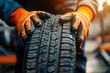 tire at repairing service garage background. Technician man replacing winter and summer tire for safety road trip. Transportation and automotive maintenance concept