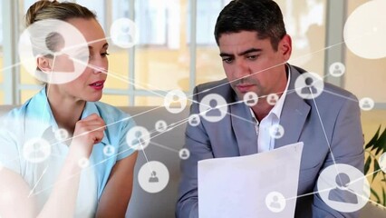 Wall Mural - Animation of network of connections with icons over diverse business people reading documents