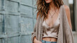 A cozy oversized cardigan layered over a silk tank top and paired with distressed jeans for a casual yet luxurious look.