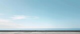 Fototapeta Sport - Tranquil Seafront Promenade with Expansive Sky View