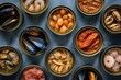 Top view of an assortment of canned food against a gray blueish backdrop. 
