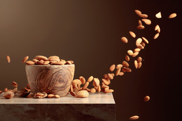 Wall Mural - Almond nuts are poured into a wooden bowl.