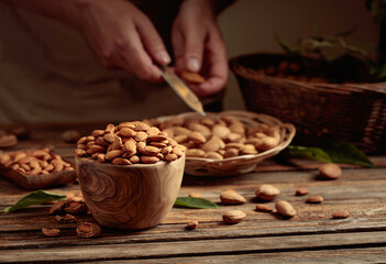 Wall Mural - Almond nuts on a wooden table.