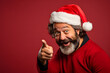 © Akash - Man in Christmas Hat with a Surprised Look, Pointing to the Side.