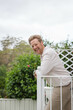 © Austockphoto - Smiling middle aged man on balcony