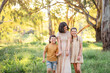 © Austockphoto - Portrait of mother and children walking together in Australian bush setting