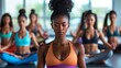 Black women in yoga class meditating with eyes closed