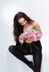Wall Mural - Beautiful young woman with bouquet of flowers