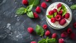 Fresh raspberries and yogurt arrangement on background, top view shot from above