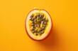 Vibrant top down of a ripe passion fruit cut in half on a bright yellow background, showcasing the seeds and juice