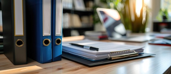 two binders containing procedures and policies are located on the office desk.