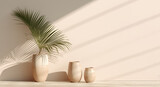 Fototapeta Miasta - Vases with a palm leaf in front of a sunlit beige wall