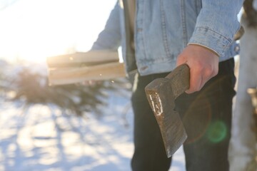 Wall Mural - Man with axe and wood outdoors on sunny winter day, closeup. Space for text