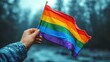 © rodrigo - gay man holding lgbt pride flag in clear sky