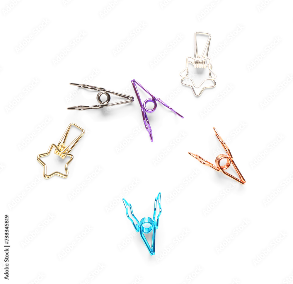 Colorful binder clips in shape of stars on white background
