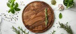 Fresh Herbs and Spices Around a Wooden Cutting Board on Marble