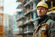 a male builder in a uniform and a helmet stands near a building under construction. Professional. Project of an apartment building. Banner place for text