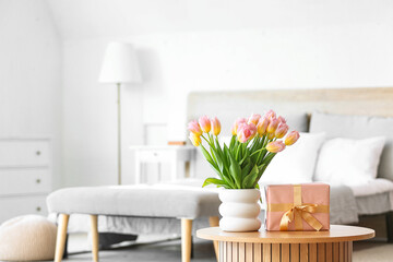 Sticker - Vase with tulips and gift box for International Women's Day on table in bedroom