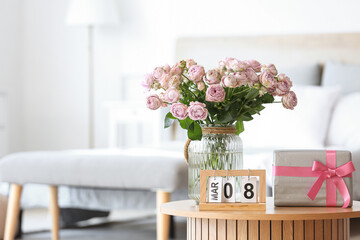 Sticker - Calendar with date of International Women's Day, roses and gift box on table in bedroom, closeup