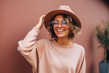 Wall Mural - Portrait of a beautiful young woman in a hat and glasses.