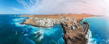 Fototapeta Desenie - Panoramic aerial view of the famous El Cotillo beach, in Fuerteventura island: View of the secluded beaches on the coast of the Atlantic Ocean, a paradise for surfing  tourists, in the Canary Islands.