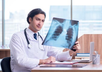 Wall Mural - Young male doctor radiologist working in the clinic