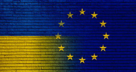 Flags of Ukraine and European Union on brick wall, banner design. International diplomatic relationships