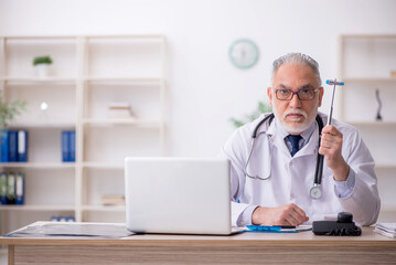 Sticker - Old male doctor neurologist sitting in the clinic