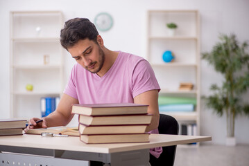 Wall Mural - Young male student sitting in the classroom