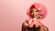 © MaskaRad - Drag Queen with pink hair with a bouquet of pink roses on a pastel peach background. black African man in a female form.