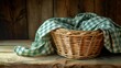 Wicker basket resting on rustic wooden table draped with green gingham fabric