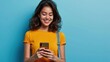 Young curious smiling happy pretty latin woman holding mobile phone, doing online shopping on cell, using apps on cellphone looking aside.