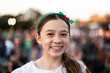 © Austockphoto - tween girl smiling at a community event with a Christmas hairband