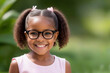Smiling cute little african american girl with two pony tails looking at camera. Portrait of happy female child. Smiling face a of black 4 year old girl looking at camera with afro puff hair